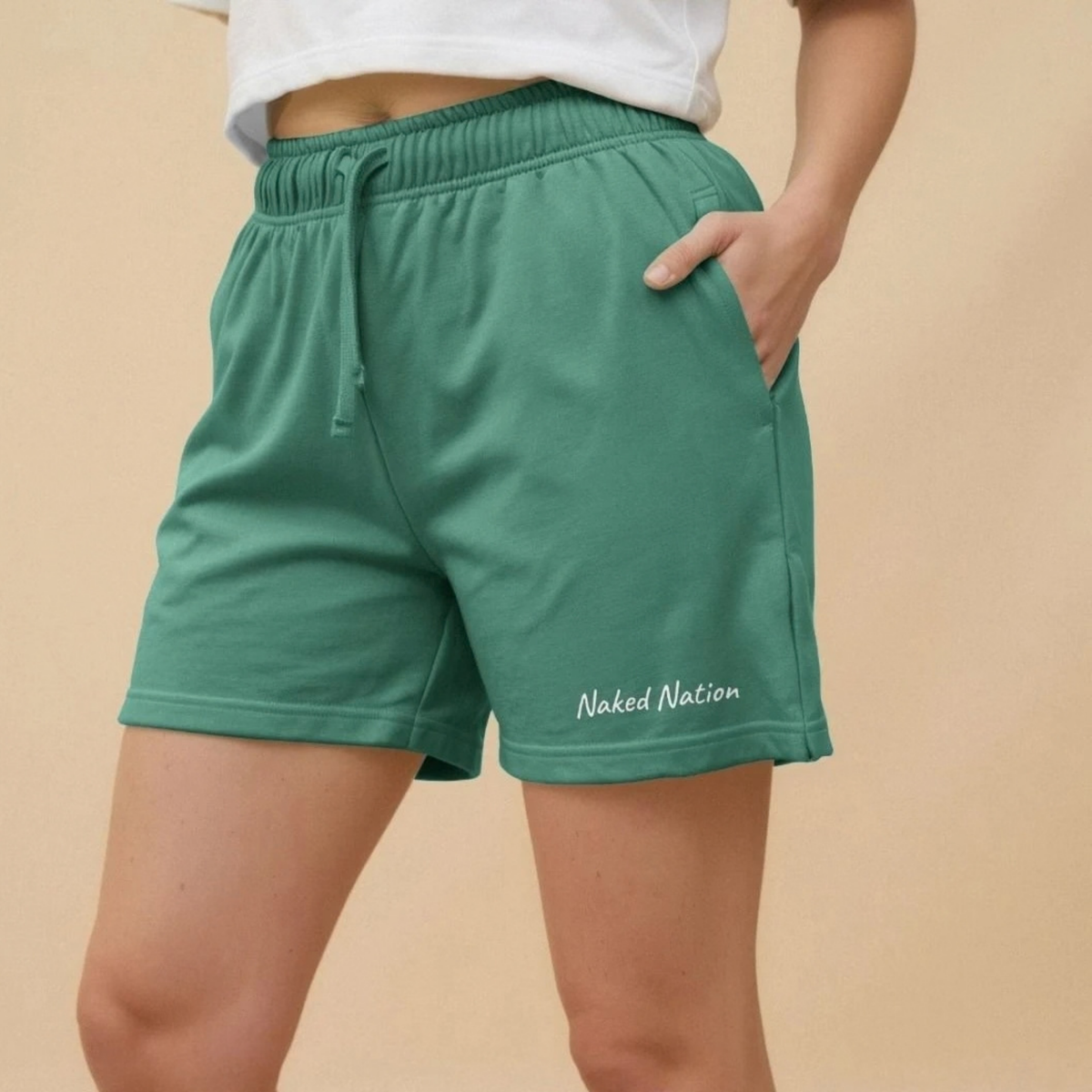 Naked Nation women's organic cotton jogger shorts in Sage Green, model wearing it
